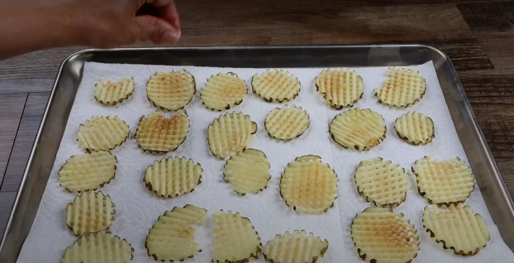 adding salt to the waffle fries